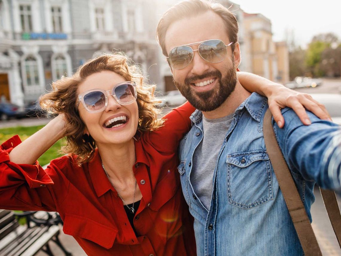 A young couple wearing sunglasses